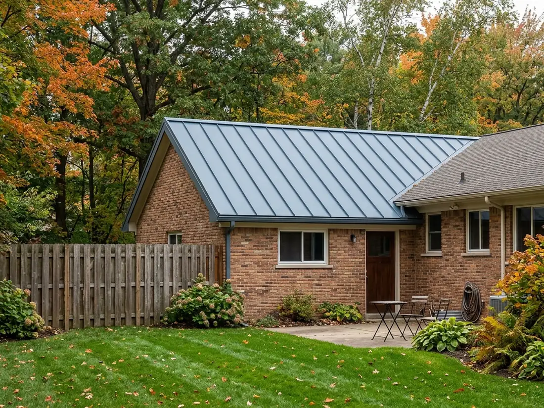 Blue-grey zinc standing seam roof with narrow seams on a gabled brick wing