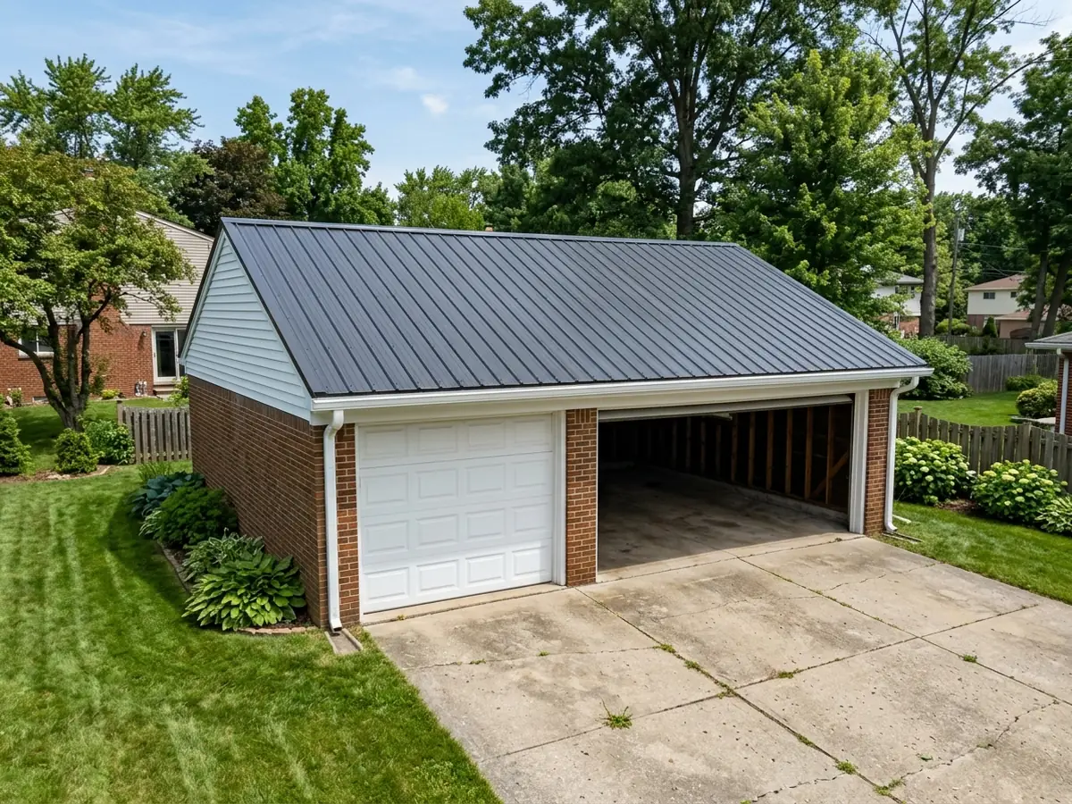 Detached brick-and-siding garage with a new charcoal ribbed steel roof, white trim and an open overhead door